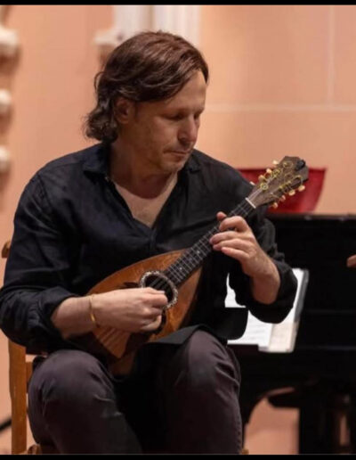 Jonathan Rudie plays a classical Italian style mandolin on stage